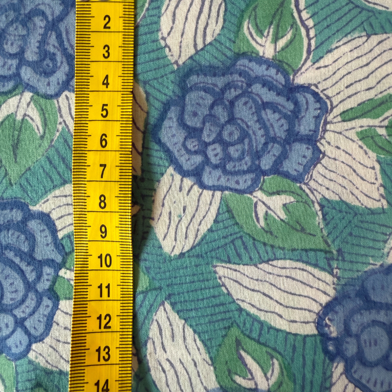 Floral fabric pattern with a yellow measuring tape on the left side