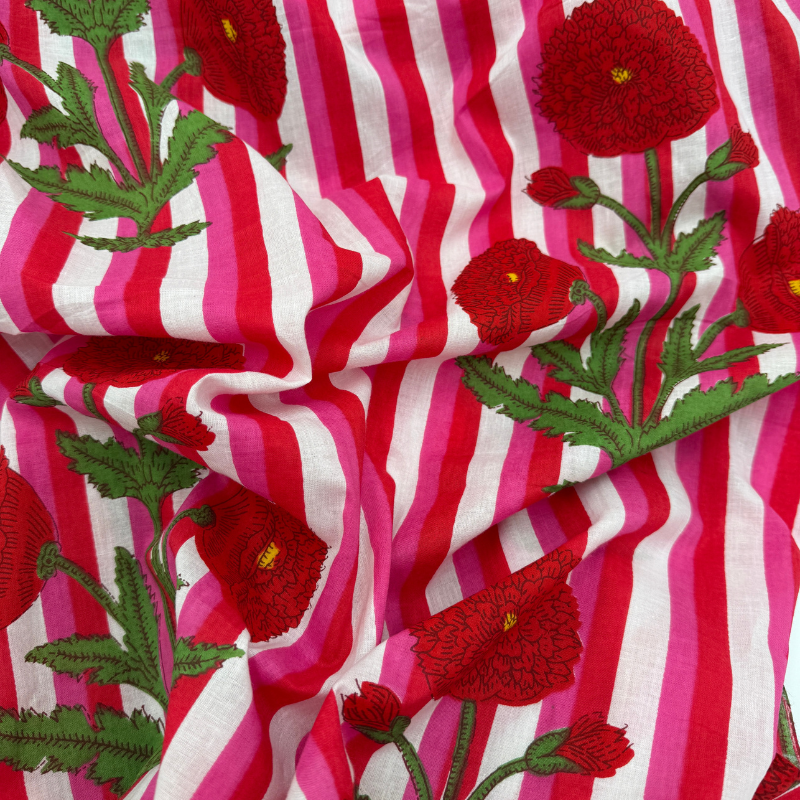 Fabric with red floral patterns and pink and white stripes