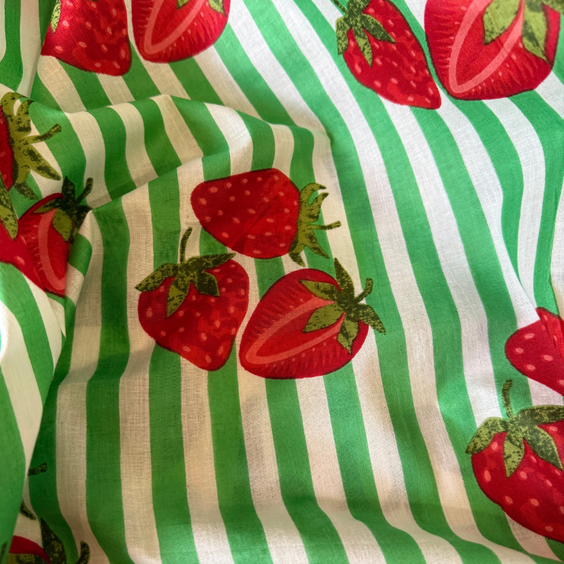 Fabric with red strawberries and green and white stripes