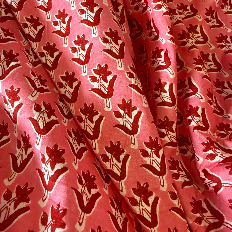 Red floral pattern on pink fabric