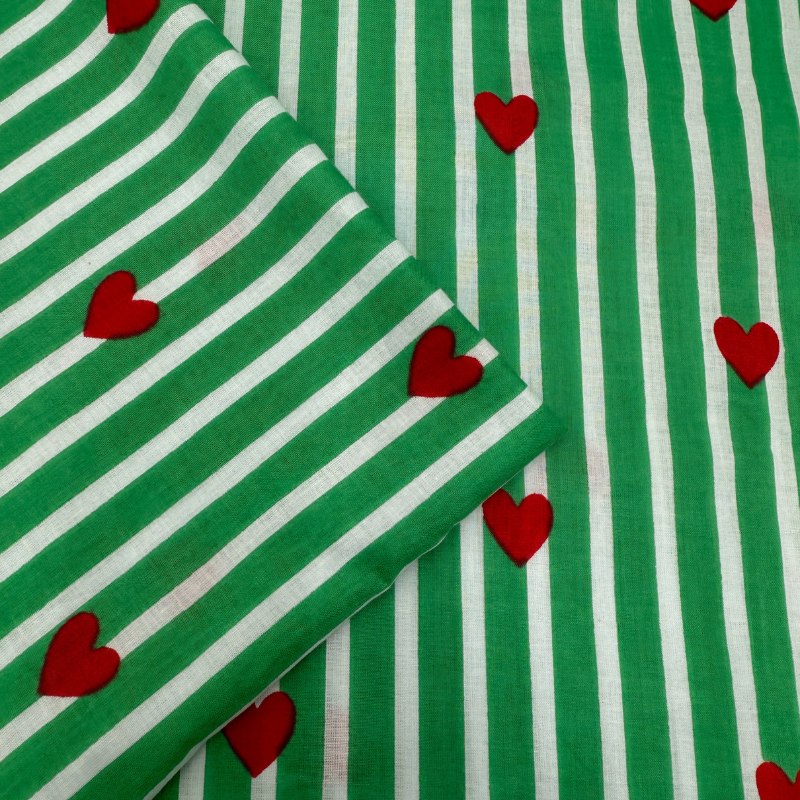 Green and white striped fabric with red hearts