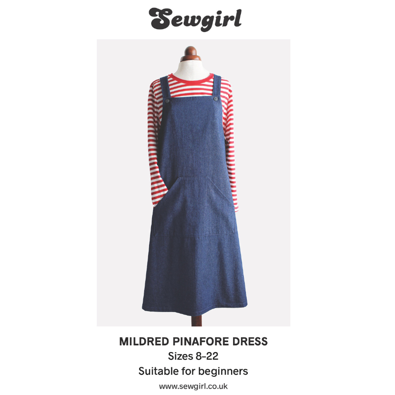 Blue pinafore dress on a mannequin with red and white striped shirt, Sewgirl branding visible