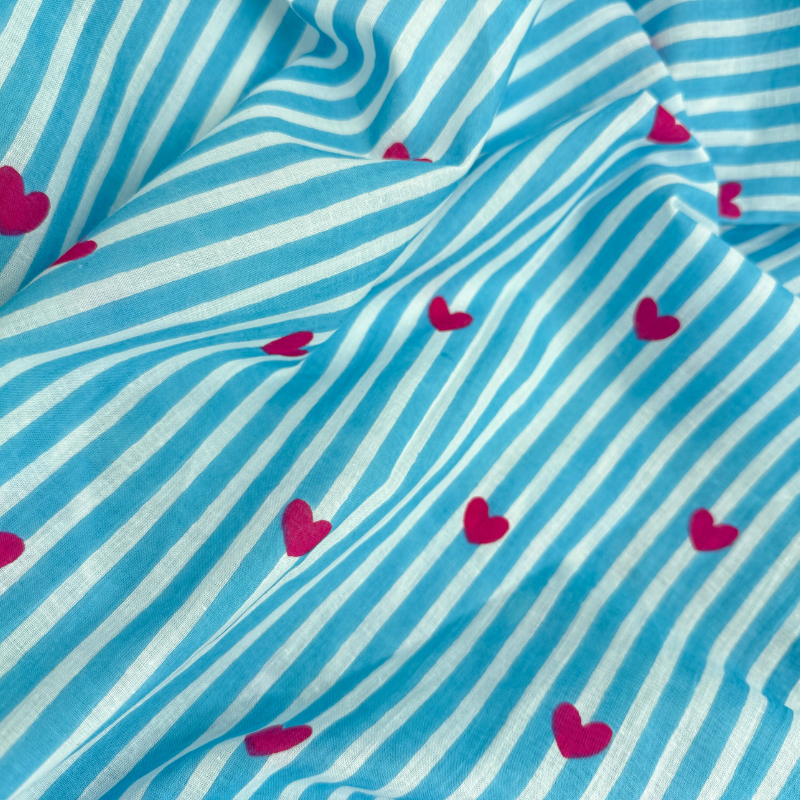 Blue and white striped fabric with pink hearts