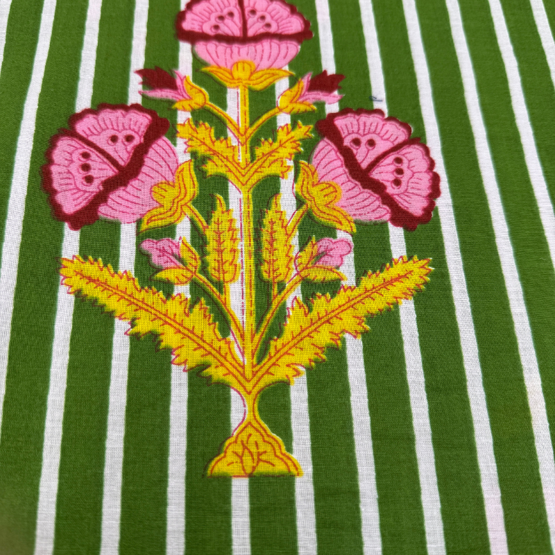 Embroidered floral design on a green and white striped fabric