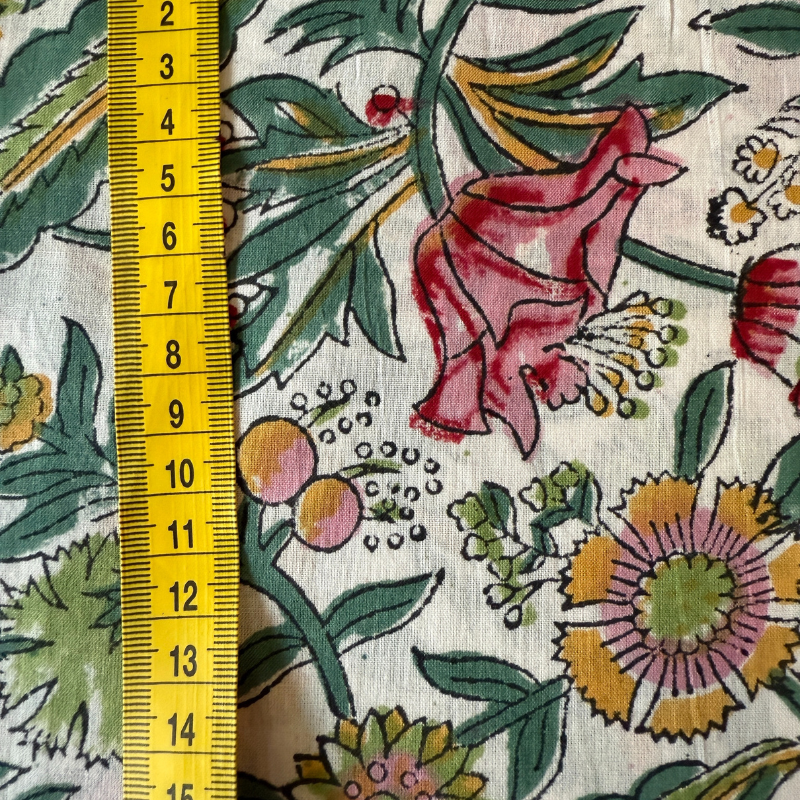 Floral fabric pattern with a yellow measuring tape on the left side