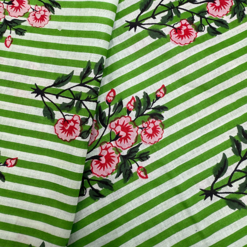 Fabric with green and white stripes and pink floral patterns