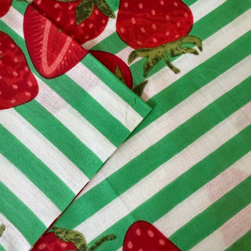 Fabric with green and white stripes and red strawberries