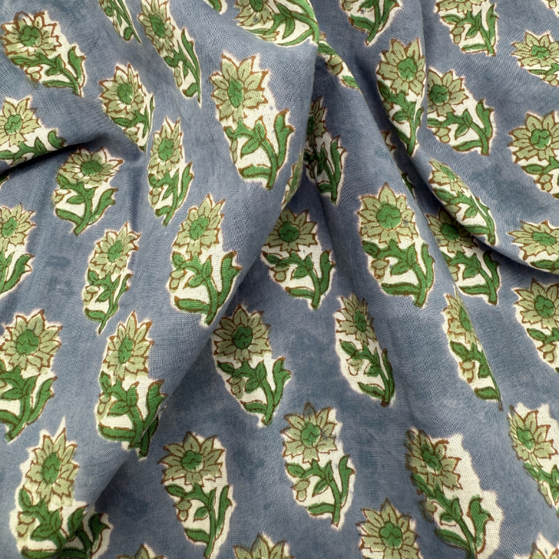 Fabric with green floral pattern on a blue background