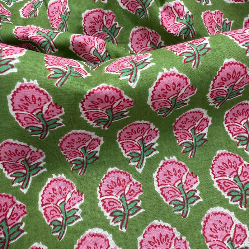Fabric with pink floral pattern on a green background