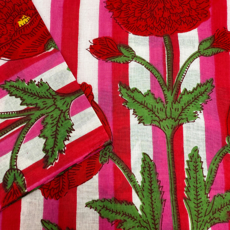 Fabric with red and green floral pattern on a striped background