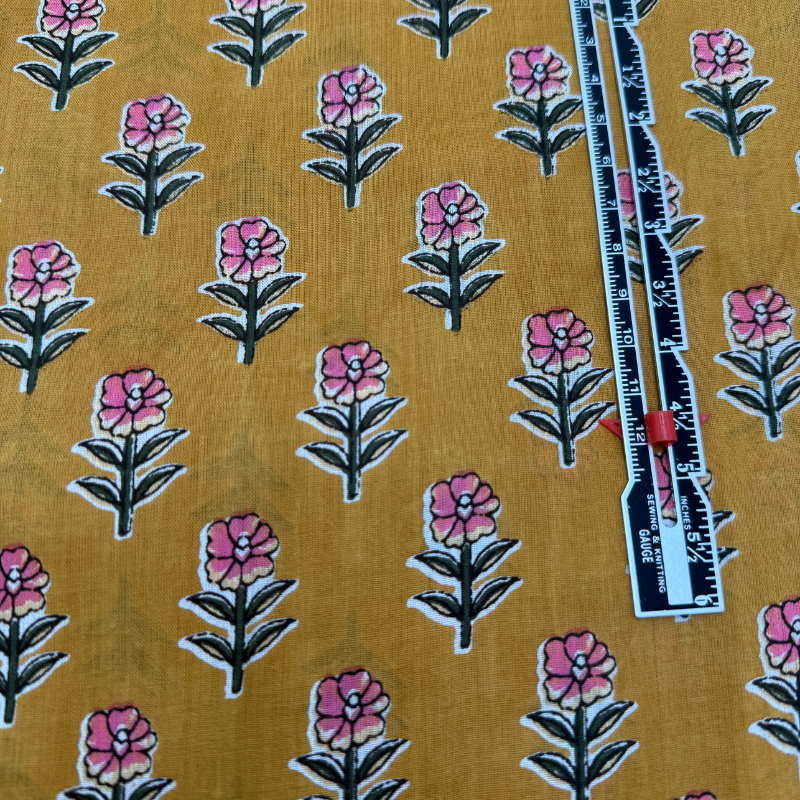 Floral pattern on fabric with a ruler for scale