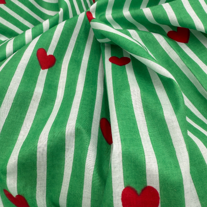 Green and white striped fabric with red hearts