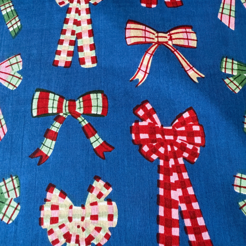 Pattern of red and white checkered bows on a blue background