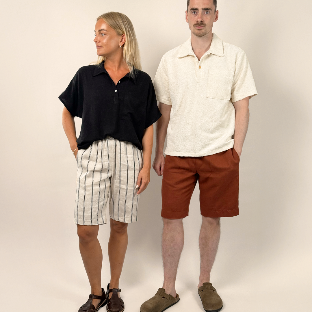 Two people standing side by side against a plain background